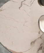 Круглый ковер Desso Sense of Marble AA81 1269 под розовый мрамор у ножки стула.