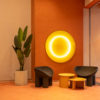 Кварцвиниловая плитка Tarkett iD Inspiration в интерьере Sky Tower. Терракотовое напольное покрытие Tarkett в зоне ожидания с круглым светильником.